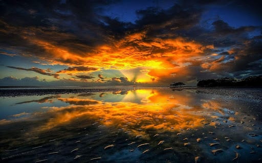 Water reflecting the sunset and clouds