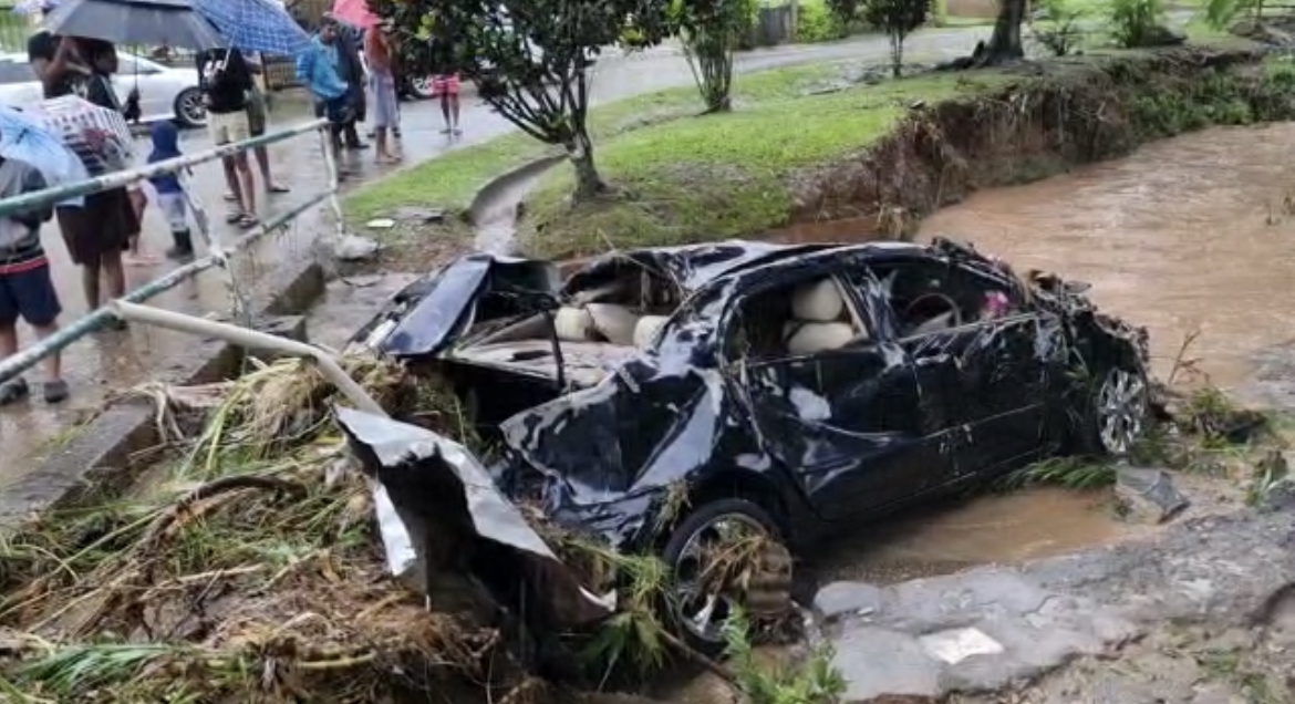 One of the two vehicles swept away due to flash floods at Dunderhill Road, Bon Air West, Arouca