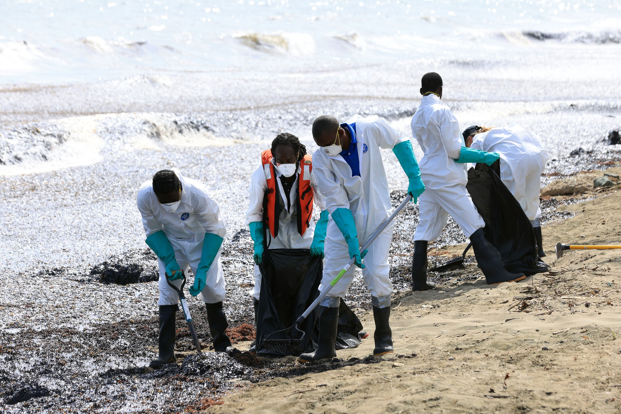 Clean-up in Scarborough, Tobago as an oil-like substance washes up on shore, saturating Sargassum. (THA)
