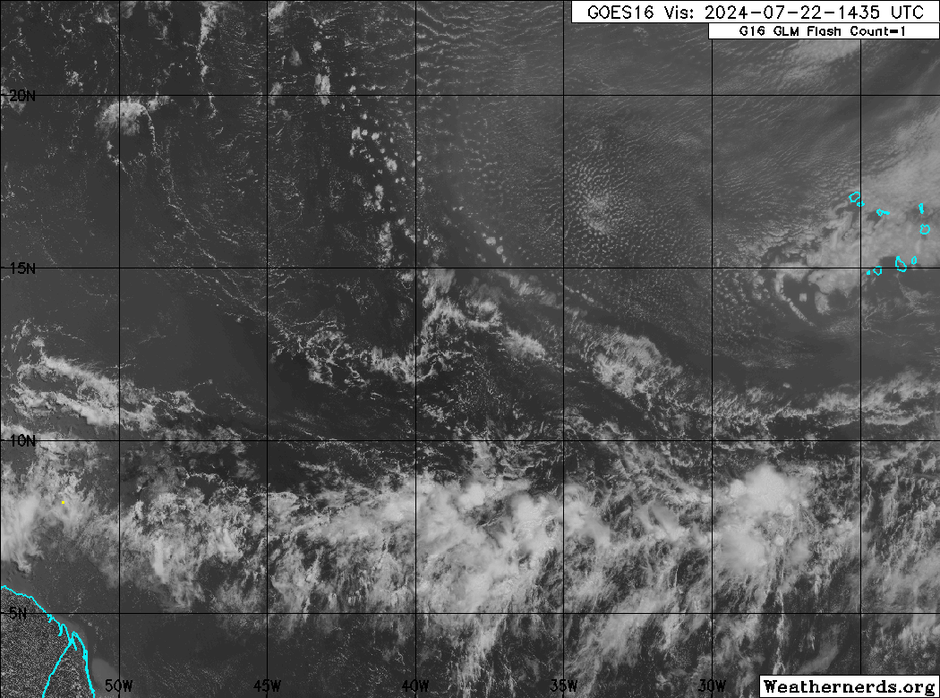 The axis of Tropical Wave 24, well east of the Lesser Antilles, producing limited showers and cloudiness where the wave axis interacts with the Intertropical Convergence Zone, while the northern half of the wave is engulfed in a thick layer of Saharan Dust (dull grey area). (Weathernerds.org)