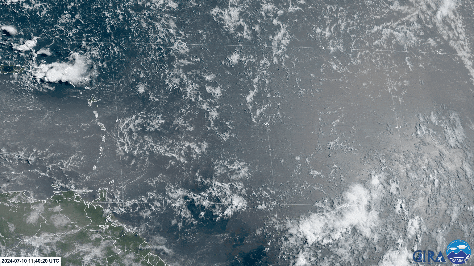 Tropical Wave 19 moving across the Windward Islands on Wednesday, July 10th, 2024, while Tropical Wave 20, still east of the Lesser Antilles, producing scattered showers and cloudiness where the wave axis interacts with the Intertropical Convergence Zone, while the northern half of the wave is engulfed in a thick layer of Saharan Dust (tan/brown area).
